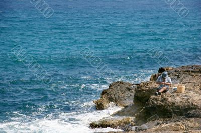 Fishman on the rocks, crete