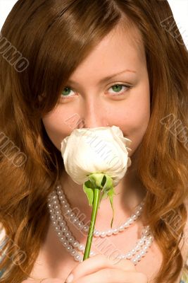 The girl smells a rose