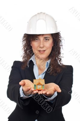 Female architect holding and showing the house