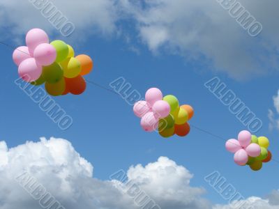 Multicolored colourful ballons in cloudy blue sky