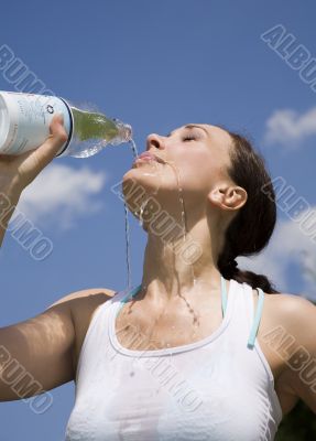 Young woman trinking water outdoors