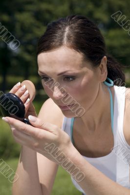 Woman powdering her face