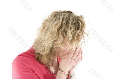 Young blond girl sneezing in the handkerchief