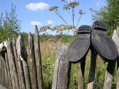 Boots on a fence