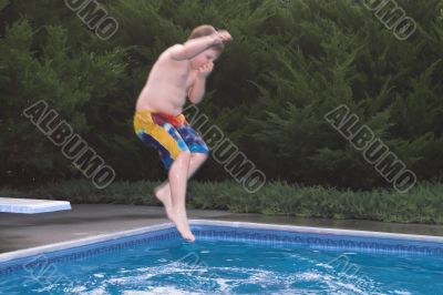 Boy Jumping In a Pool