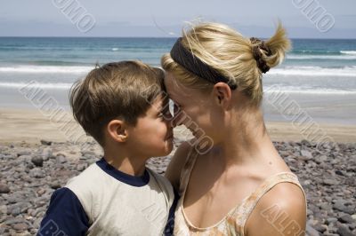 Smiling Boy and  happy mom in the beach