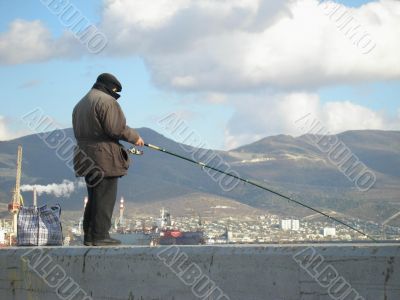 Novorossiysk, a fisherman on the breakwater