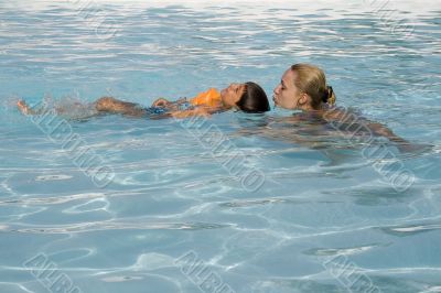 Boy and mom in the swimming pool