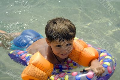 Happy boy swimming in the sea