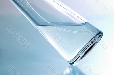 Transparent bottle of spirits on a blue background