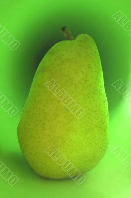 Green pear on a green background