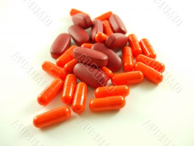 Red and Orange Pills On White