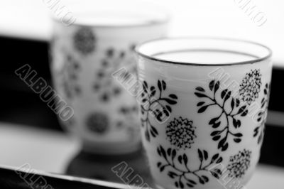 two black and white cups on a black tray