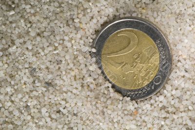 lost euro coin in beach sand