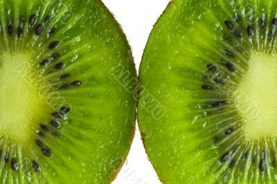 Two kiwis with seeds isolated on white