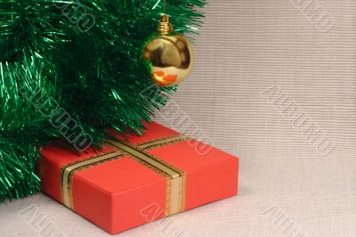 Gift box, ball and tinsel