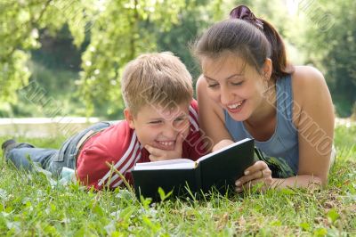 Mum and the son reads the book