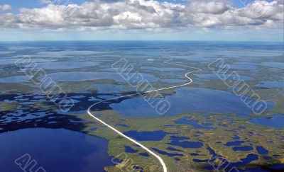 The Road through marsh on oilfield.