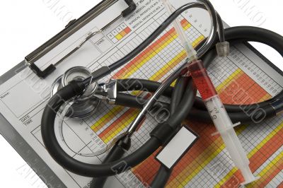 Medical charts, with stethoscope and syringe