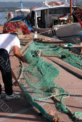 Fisherman with green nylon fishing nets