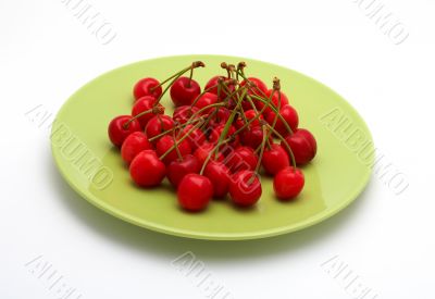 Cherries on the green plate