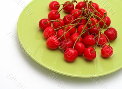 Cherries on the green plate