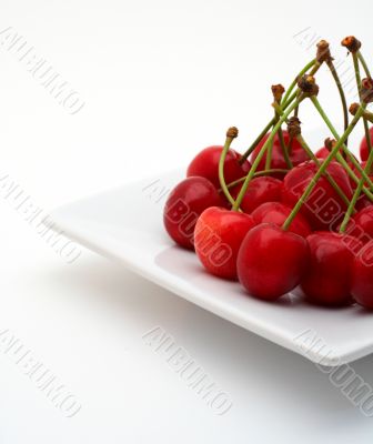 Cherries on the white plate