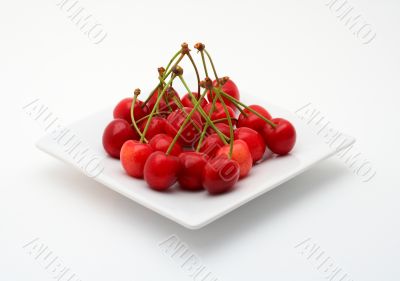 Cherries on the white plate