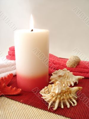 pink candle, towels and seashells