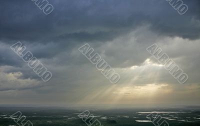 The sunrays and clouds.