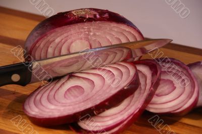 Sliced red onion and knife