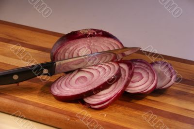 Sliced red onion and knife