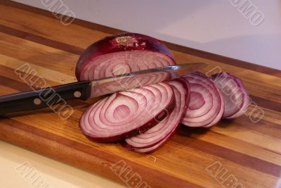 Sliced red onion and knife
