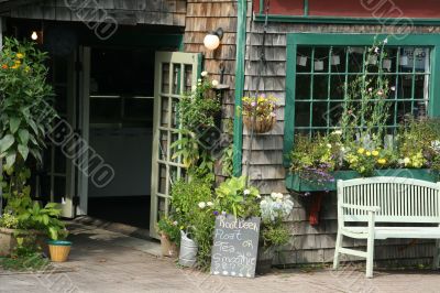 Shopfront with flowers in hanging pots