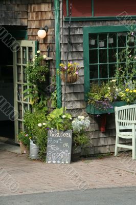 Shopfront with flowers in hanging pots