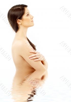 topless brunette in water