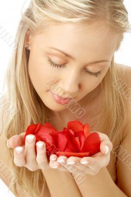 lovely blond in spa with red rose petals