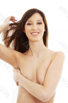 smiling topless brunette with long hair