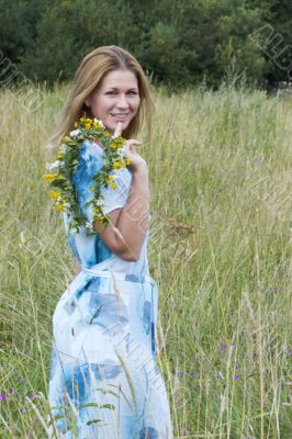 Girl wearing blue dress in meadow