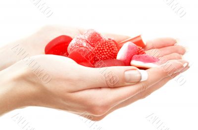 hands full of red bonbons
