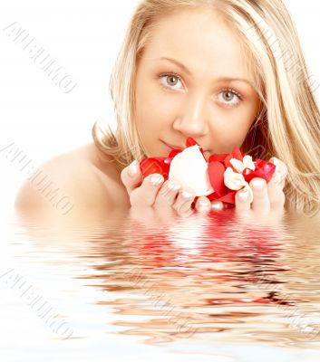 happy blond in water with red and white petals