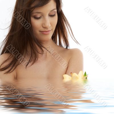 brunette with yellow lily flowers in water