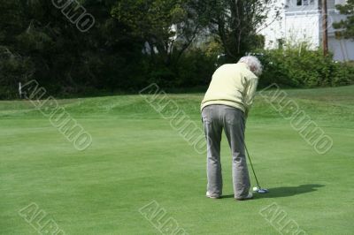 Woman golfer on putting green