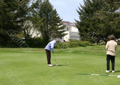 Woman golfer on putting green