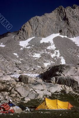 Yellow tent in alpine meadow
