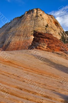 Light clouds above striped mountains