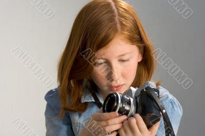 Girl with old SLR photo camera