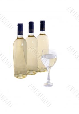 wine glass with reflection of  wine bottles