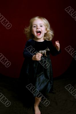 happy little girl in party dress with toy