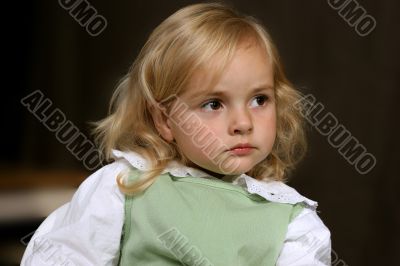 cute little serious angel in green dress